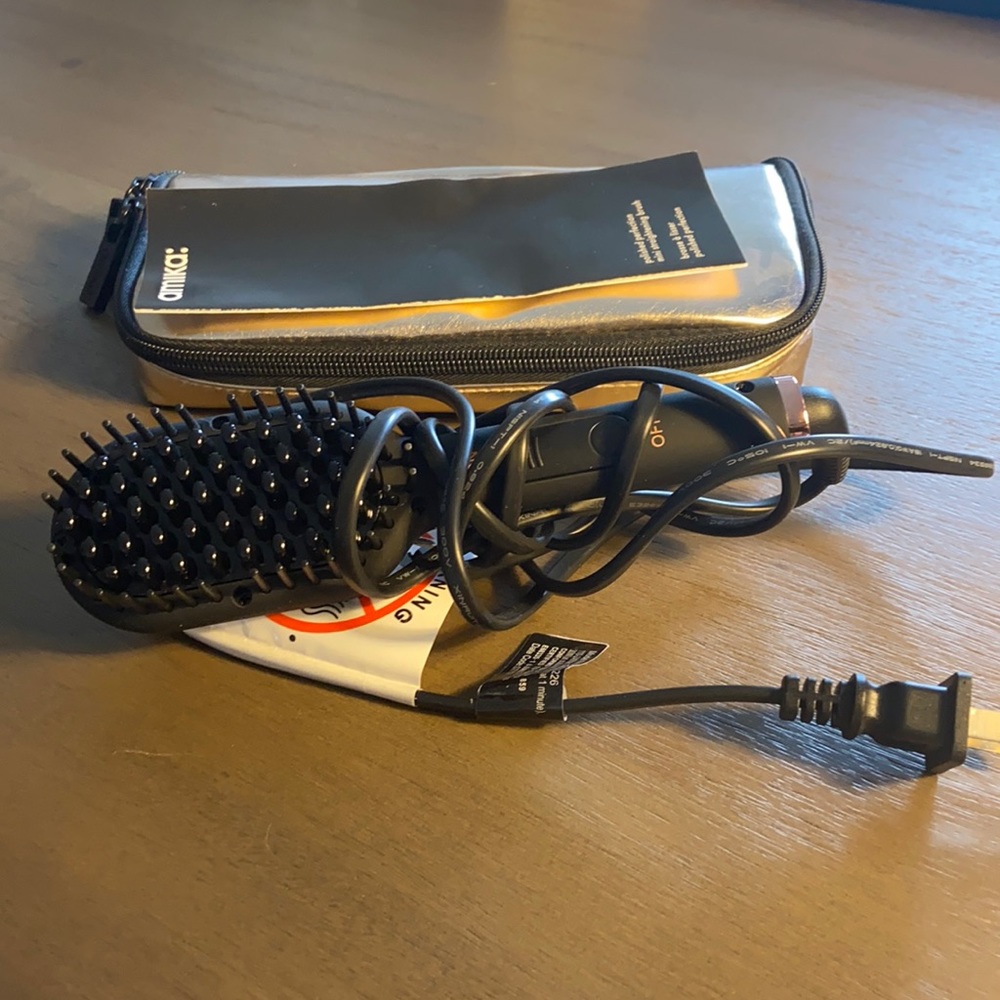 Amika heated brush styling travel tool with rose gold case